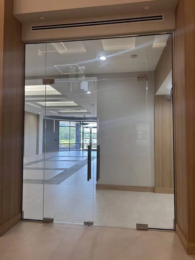 Frameless glass entry doors with patch fittings