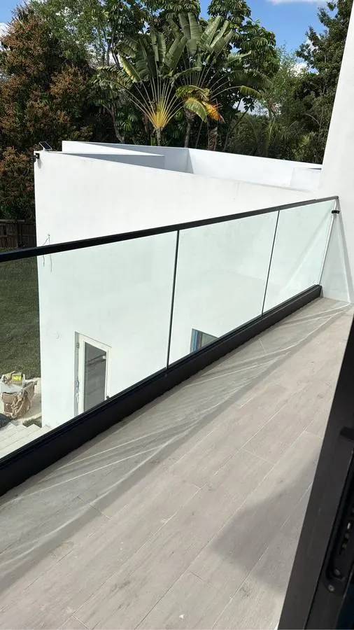 Glass terrace railing with black top rail
